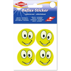 Könnte beinhalten: Eine Packung mit vier runden gelben Smiley-Aufklebern mit weißen Augen, schwarzen Pupillen und schwarzen geschwungenen Mündern. Die Verpackung ist blau-weiß mit dem Text KLEIBER Reflex-Sticker und weiteren mehrsprachigen Produktinformationen.