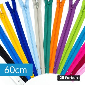 Op de afbeelding: Een collectie ritsen van 60cm in diverse kleuren waaronder geel, blauw, lichtblauw, beige, groen, oranje, paars, limoengroen en roze. Elke rits is voorzien van een bijpassende trekker en metalen tanden, gerangschikt in een waaiervorm.