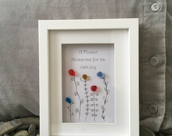 A flower blossoms. Oscar Wilde quote and sea glass flowers