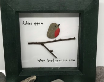 Robins appear, pebble picture depicting robin on a branch with wording