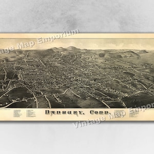 May include: An antique black and white bird's eye view map of Danbury, Conn. The map shows the layout of the city with streets, buildings, and surrounding landscape.
