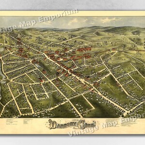 May include: An antique bird's-eye view map of Danbury, Connecticut, printed in vibrant colors, showing the town's layout with streets, buildings, and surrounding landscape.