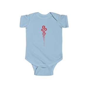 May include: A light blue baby onesie with a red graphic of a cluster of circles, resembling a firework or a stream of bubbles.