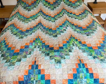 Handgemaakte Bargello-quilt: batik patchworkdeken, blauwgroen oranje