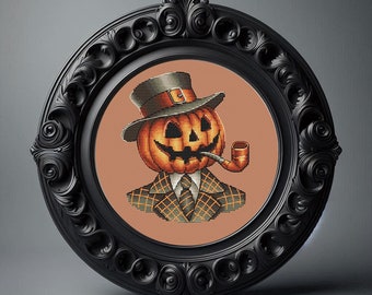 May include: A cross-stitch embroidery of a jack-o'-lantern wearing a green hat and a plaid suit, holding a pipe in its mouth.