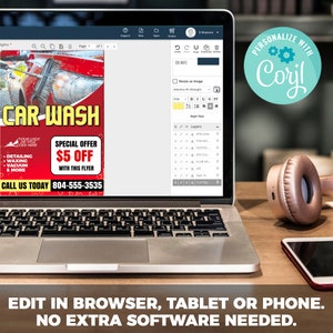May include: A laptop computer screen displaying a car wash flyer with the text "CAR WASH" and "SPECIAL OFFER &pound;5 OFF". The flyer is on a blue background with white text. The laptop is on a wooden table with a phone and headphones.