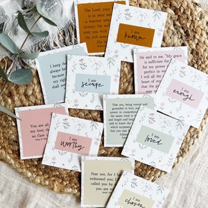 May include: A set of 10 affirmation cards with floral designs and inspirational quotes. Each card features a different affirmation, such as "I am secure", "I am worthy", "I am known", "I am loved", "I am enough", and "I am chosen".
