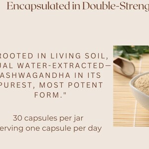 May include: A white bowl filled with light brown ashwagandha powder, sitting on a woven bamboo mat. The text "ROOTED IN LIVING SOIL, DUAL WATER-EXTRACTED- ASHWAGANDHA IN ITS PUREST, MOST POTENT FORM." is written below the bowl. The text "30 capsules per jar Serving one capsule per day" is written below the text.