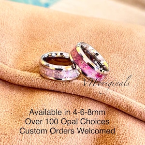 May include: Two silver rings with colorful opal inlays. The rings are set against a tan background. The text on the image says "Available in 4-6-8mm, Over 100 Opal Choices, Custom Orders Welcomed."