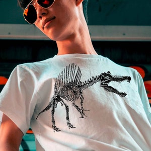 Dinosaur shirt. Spinosaurus. In Unisex or as a Women&#39;s Off Shoulder Slouchy Top. Buy any 2 shirts or tanks and get a 3rd Shirt FREE!!