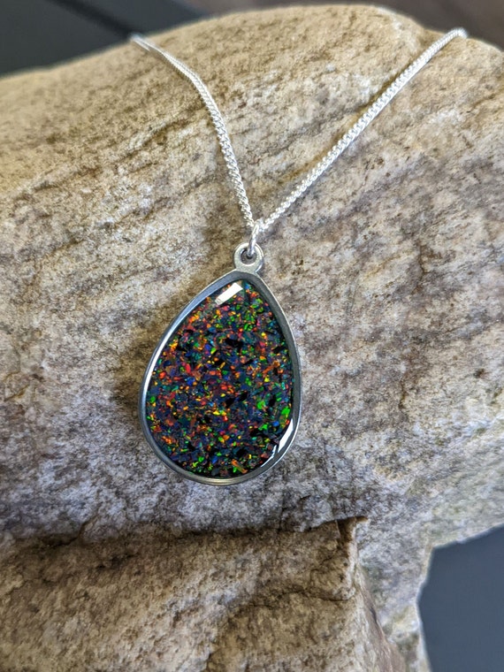 A CRYSTAL MOUNTAIN 18KT WHITE GOLD & DIAMOND AUSTRALIAN SOLID BLACK OPAL  NECKLACE