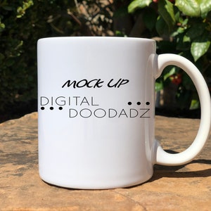 May include: White ceramic mug with black text that reads "MOCK UP DIGITAL ... DOODADZ".