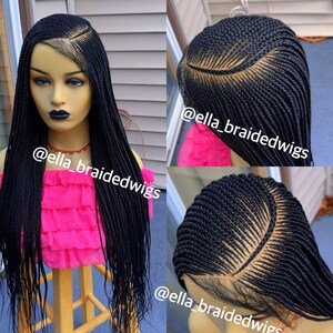 May include: A black braided wig with a lace front. The wig is styled in a long, straight style. The wig is on a mannequin head. The text "@ella_braidedwigs" is visible in the image.