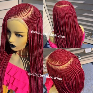 May include: A burgundy braided wig with a lace front. The wig is styled in a long, straight style. The wig is shown on a mannequin head. The text "@ella_braidedwigs" is visible on the image.