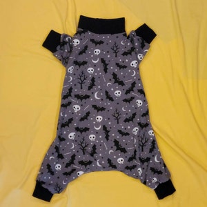 Dark Gray With Scary Skulls, Spooky Trees And Black Bats. Lightweight Cotton Pjs/One piece. Custom Sizing Offered.
