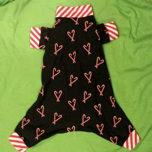 Christmas Candy Canes. Thin, Black Cotton Knit Fabric With Red & White Candy Canes. Several Trim Options. Custom Sizing Available.