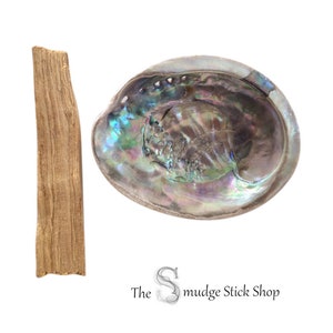 May include: A brown wooden smudge stick and a large abalone shell with iridescent colours. The shell is used for smudging ceremonies.