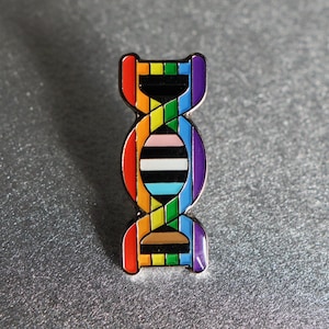 May include: A rainbow-coloured DNA double helix pin with a black, white and light blue stripe in the centre.