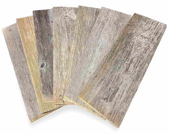 May include: A set of six reclaimed wood planks, each with a unique weathered finish, ranging from light brown to gray. The planks have a rustic, distressed look and are perfect for adding a touch of farmhouse charm to any project.
