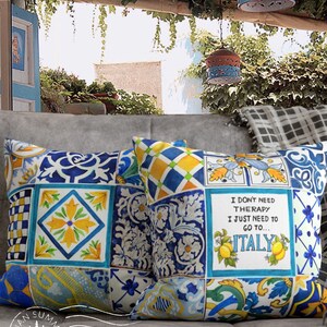 May include: Two decorative throw pillows with a blue and yellow Italian tile pattern. One pillow features the text "I don't need therapy I just need to go to... ITALY".