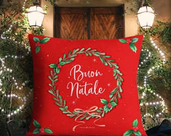May include: Red throw pillow with a green wreath and the words "Buon Natale" in white script. The wreath is decorated with red berries and a red ribbon.
