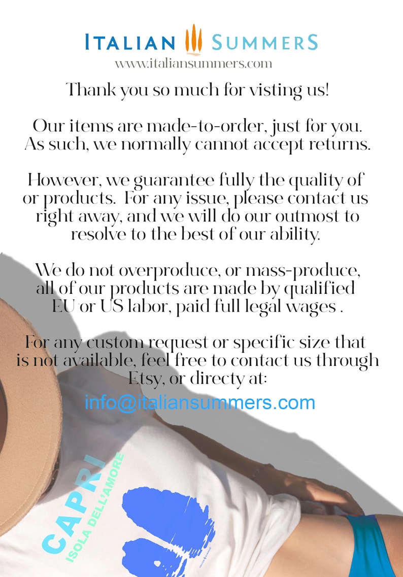 May include: A white t-shirt with a blue graphic of the island of Capri, Italy. The text "Capri Isola Dell'Amore" is printed on the shirt. The shirt is being worn by a person lying on a beach.