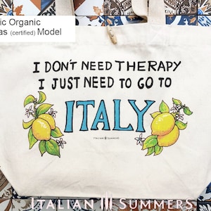 Tote bag with the quote I don't need therapy, I just need to go to Italy, flanked by Amalfi Coast lemons. Designed and sold by Italian Summers