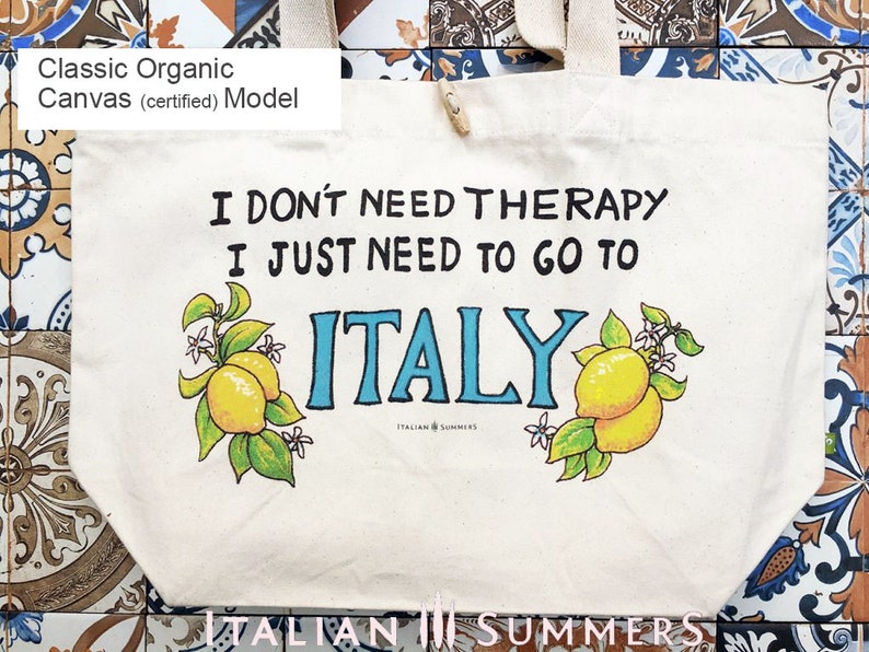 Tote bag with the quote I don't need therapy, I just need to go to Italy, flanked by Amalfi Coast lemons. Designed and sold by Italian Summers