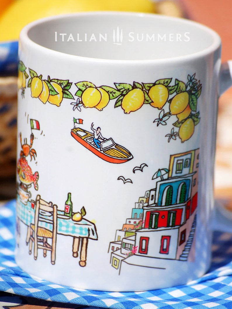 May include: White ceramic mug with a colorful illustration of a boat, a small town, and a table with a chair. The mug has the text "ITALIAN SUMMERS" printed on the top.