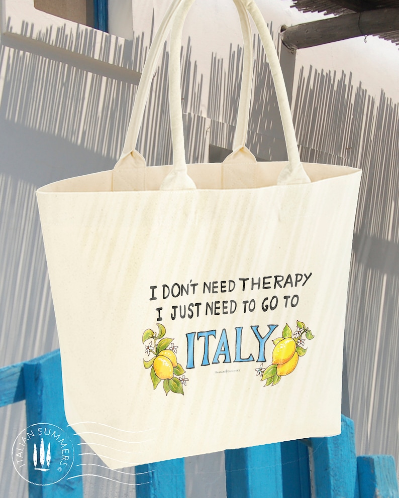 Tote bag with the quote I don't need therapy, I just need to go to Italy, flanked by Amalfi Coast lemons. Designed and sold by Italian Summers