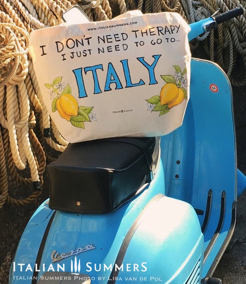 Tote bag with the quote I don't need therapy, I just need to go to Italy, flanked by Amalfi Coast lemons. Designed and sold by Italian Summers