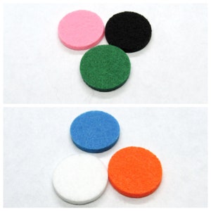 May include: Six round felt pads in various colors: pink, black, green, blue, white, and orange. The pads are about 2 inches in diameter.