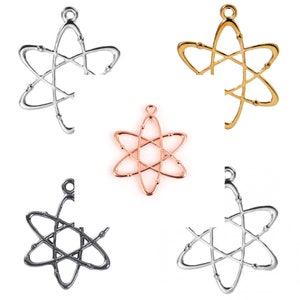 May include: Five atom charm pendants in different colours: silver, gold, rose gold, black, and white. The charms are all the same design, a stylised atom with a circle in the centre and six points.