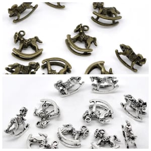 May include: A collection of antique silver and bronze rocking horse charms. The charms are detailed and have a vintage look.