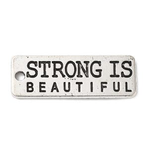 May include: Silver charm with a white background and black text that reads "Strong is Beautiful".