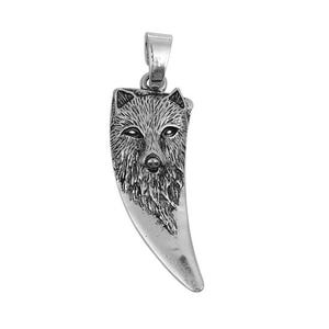May include: Silver-toned pendant in the shape of a wolf's tooth. The pendant features a detailed carving of a wolf's face at the top, with intricate fur and facial features. The pendant has a loop for a chain or cord.