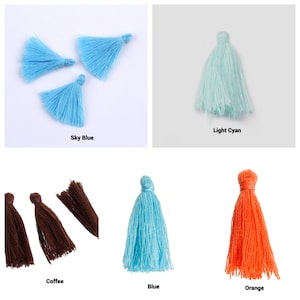 May include: Assortment of colorful tassels in sky blue, light cyan, coffee, blue, and orange. The tassels are made of soft yarn and are perfect for adding a touch of whimsy to your crafts.