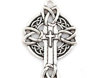 May include: Silver Celtic cross pendant with intricate knotwork design. The cross is detailed with a smaller cross in the center.
