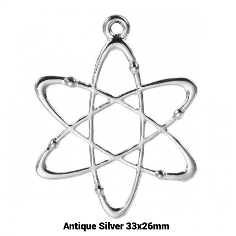 May include: Antique silver atom charm pendant, measuring 33x26mm. The charm is a detailed, openwork design of an atom with a loop at the top for hanging.