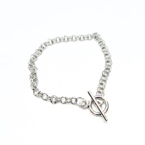 May include: A silver chain bracelet with a toggle clasp.