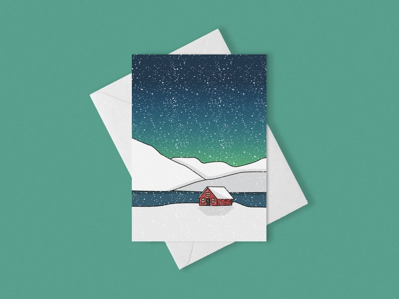 May include: A greeting card featuring a winter landscape with a red cabin, snow-covered hills, and a starry night sky. The card is inside a white envelope, set against a teal background.