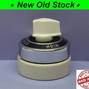 May include: A white ceramic rotary switch with a chrome trim and a white knob. The switch has three settings: "HIGH", "MED", and "LOW". The switch is labeled "MADE IN USA".