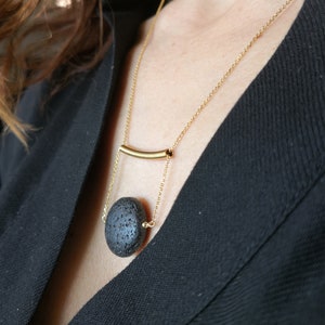 This real lava necklace is great Aromatherapy jewelry!

At the same time this 	Lava stone pendant, is a unique fidget necklace.
 
You will love this LAVA rock Diffuser Necklace.

Natural lava stone 
925 sterling silver that is yellow gold filled
