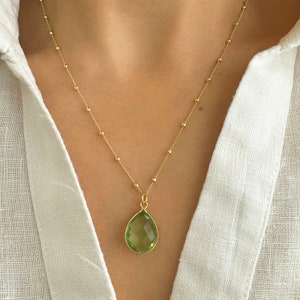 Raw Peridot Necklace in a Satellite chain. 
You will love the bright green color of the peridot pendant.
925 Sterling Silver, 24K Gold finish.
Peridot necklace is great for wearing alone or as a stacking necklace.
Peridot  promotes peace and balance.