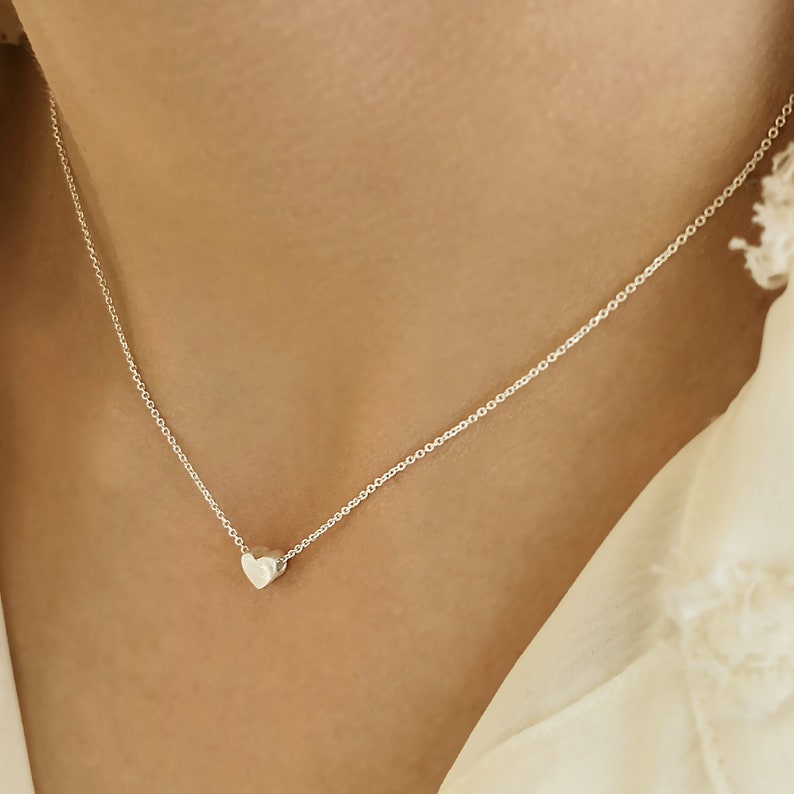 Minimalist heart Necklace with an extra tiny heart pendant
Sterling Silver 925   
The small heart necklace adds a sparkling shine to your style.
With a matt but shiny finish that makes is so unique!

Ideal for a birthday or Bridesmaid Gift