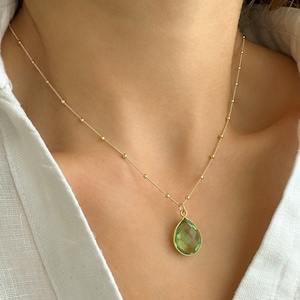 Raw Peridot Necklace in a Satellite chain. 
You will love the bright green color of the peridot pendant.
925 Sterling Silver, 24K Gold finish.
Peridot necklace is great for wearing alone or as a stacking necklace.
Peridot  promotes peace and balance.