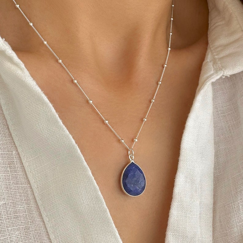 Genuine Raw Blue Sapphire Necklace 
A Good Vibes Necklace to offer as a September Birthstone Necklace.

A Real Blue Sapphire Teardrop pendant in a satellite chain necklace.

 High-Quality Solid 925 Sterling Silver

 Sterling Silver ∙ 24K Gold