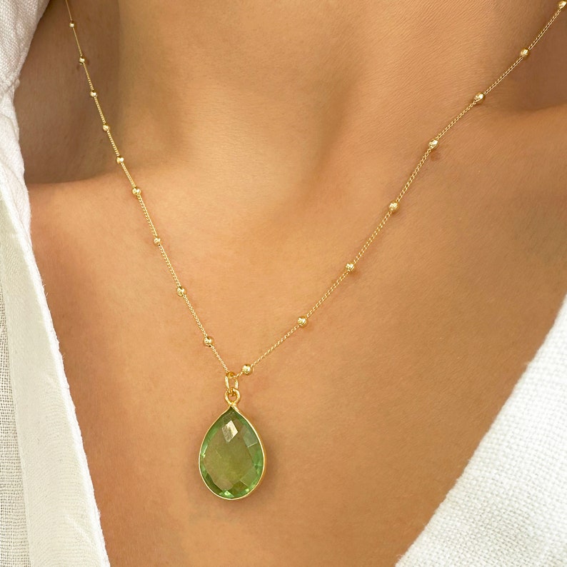 Raw Peridot Necklace in a Satellite chain. 
You will love the bright green color of the peridot pendant.
925 Sterling Silver, 24K Gold finish.
Peridot necklace is great for wearing alone or as a stacking necklace.
Peridot  promotes peace and balance.