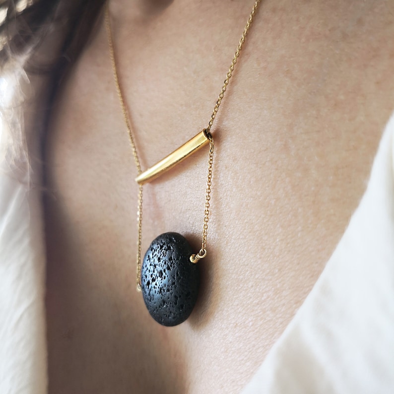 This real lava necklace is great Aromatherapy jewelry!

At the same time this 	Lava stone pendant, is a unique fidget necklace.
 
You will love this LAVA rock Diffuser Necklace.

Natural lava stone 
925 sterling silver that is yellow gold filled