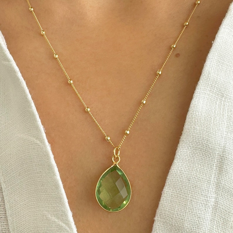 Raw Peridot Necklace in a Satellite chain. 
You will love the bright green color of the peridot pendant.
925 Sterling Silver, 24K Gold finish.
Peridot necklace is great for wearing alone or as a stacking necklace.
Peridot  promotes peace and balance.